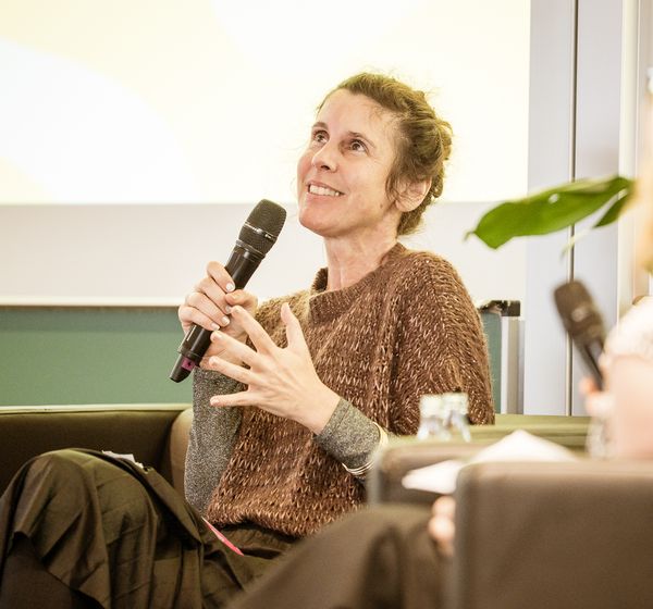 Speakerin erzählt mit Mikrofon in der Hand