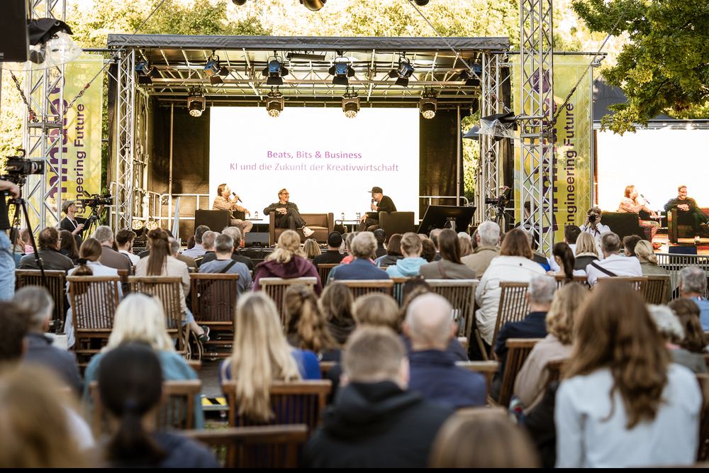 Publikum vor der großen Bühne bei einem Panel zu KI und Kreativwirtschaft